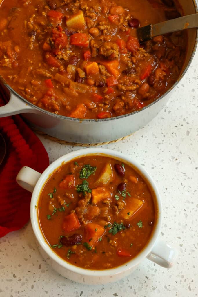 This Pumpkin Chili is a tasty change from the traditional red chili with red bell pepper, sweet potato, ground cinnamon, and pumpkin puree.