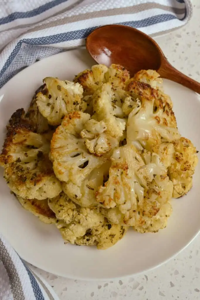 A heart healthy easy roasted cauliflower side dish made with wholesome ingredients like olive oil, Parmesan cheese, dried herbs and spices.