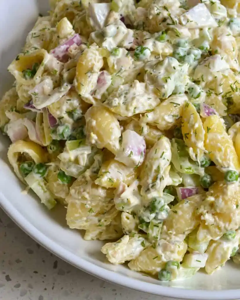 Tuna and pasta Salad with tuna, peas, celery, onion, pickle relish, dill and mayo into a tasty easy lunch or side.