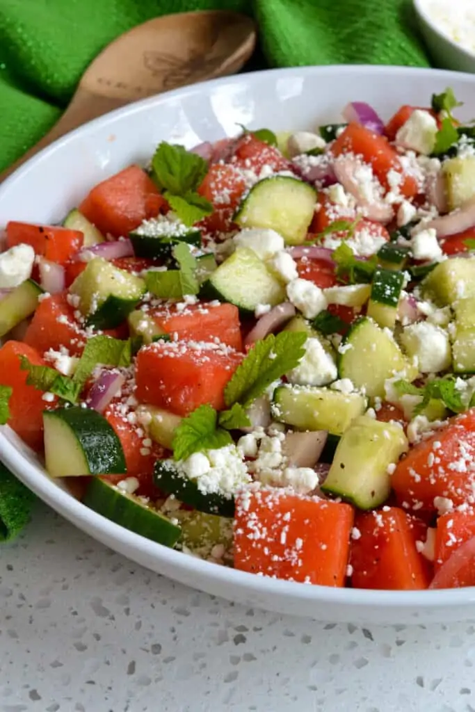 This Watermelon Salad brings the unique flavors of crisp cucumber, salty feta cheese, sweet red onion, garden fresh mint and sun ripened sweet watermelon together in a lightly sweetened lime drizzle. 