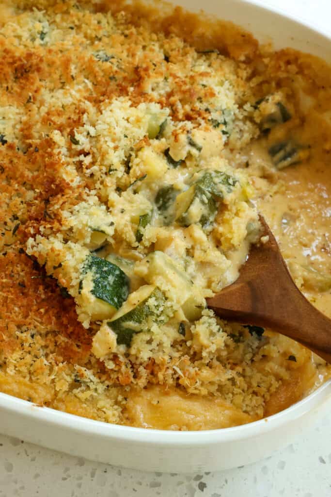 A fresh zucchini casserole with sautéed onions and garlic in a creamy cheese sauce topped with buttery Parmesan Panko breadcrumbs