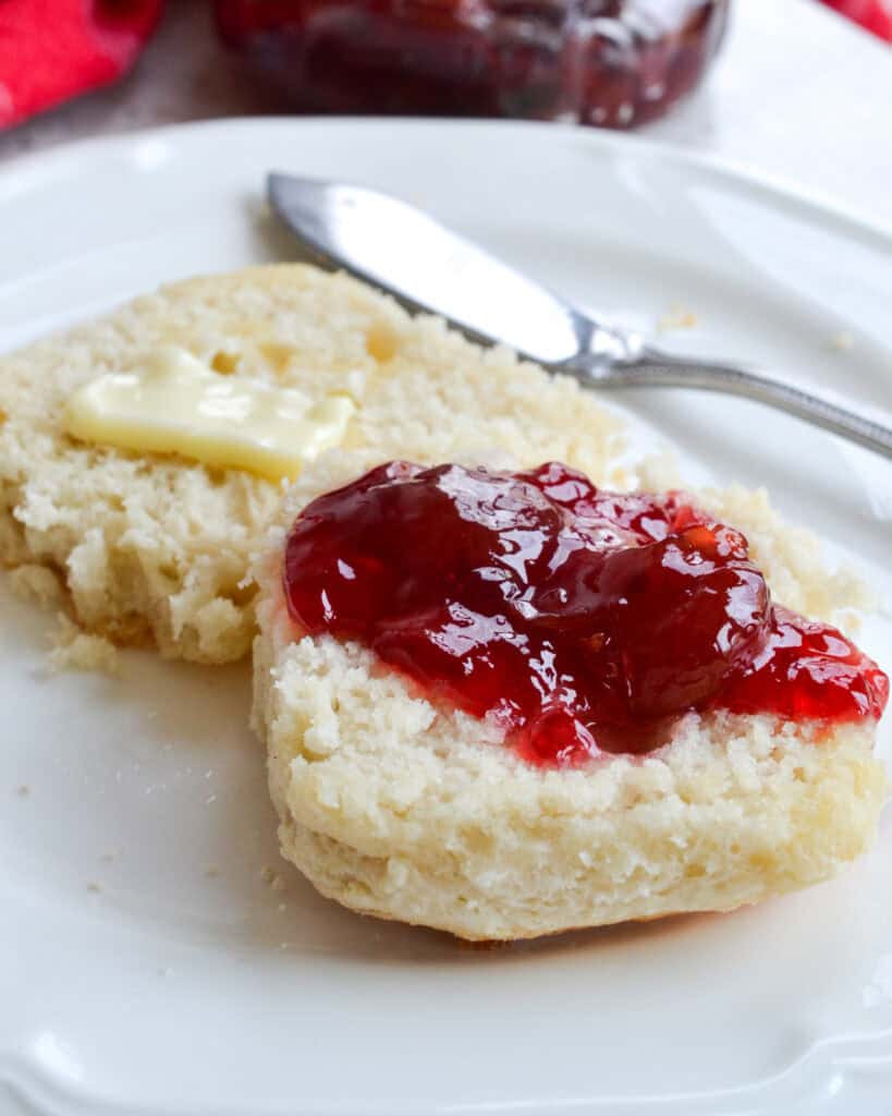 Butter and strawberry preserves on a split 7up biscuit. 