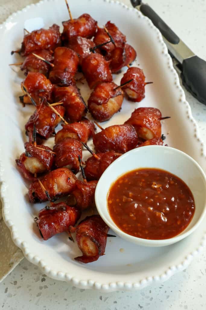 A delectable easy party appetizer of bacon wrapped water chestnuts basted in a slightly sweet tangy Asian sauce.