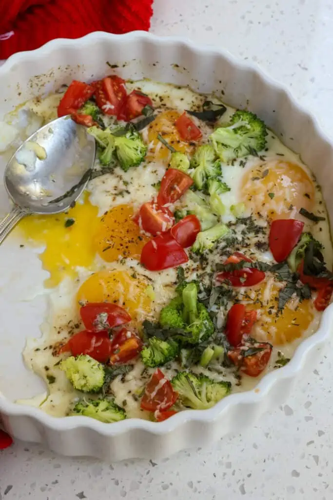This Baked Eggs Recipe with broccoli, tomatoes, fresh herbs, and grated Parmesan Cheese is quick and easy enough for a weekday breakfast but elegant enough for company. 