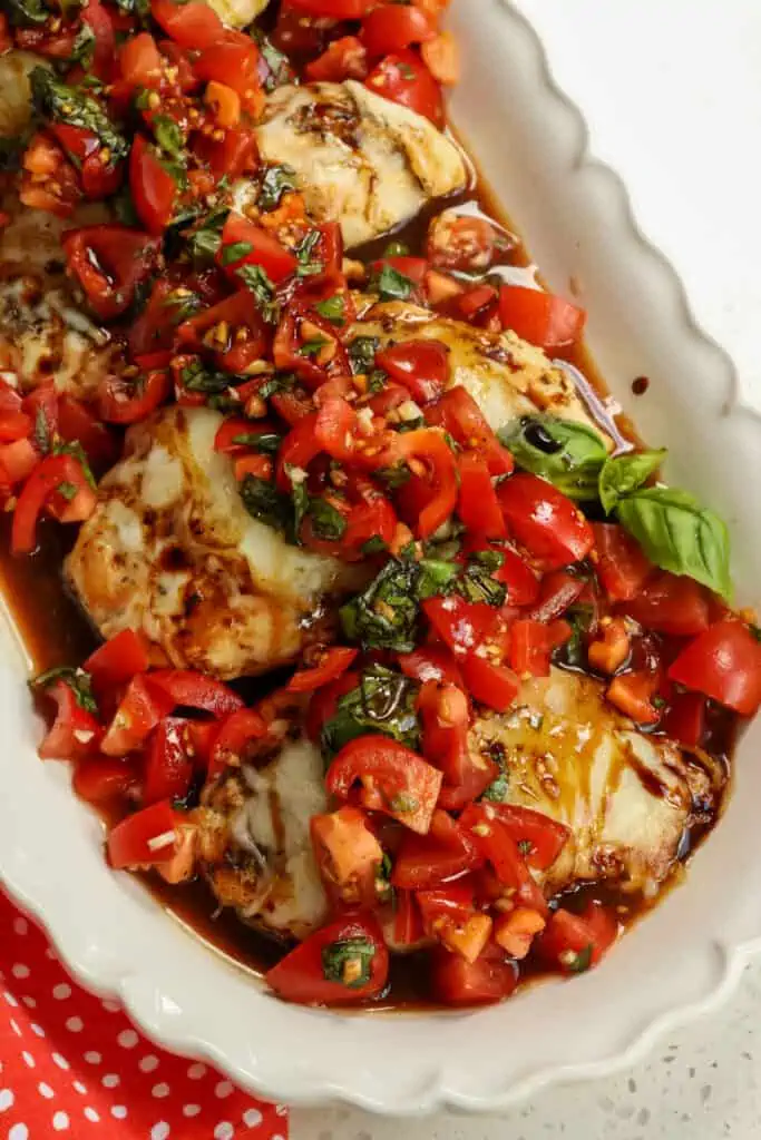 This Bruschetta Chicken combines Italian seasoned pan seared chicken topped with melted mozzarella and sun-ripened tomatoes, fresh garden basil, and sweet garlic all drizzled with a sweet flavorful balsamic glaze.