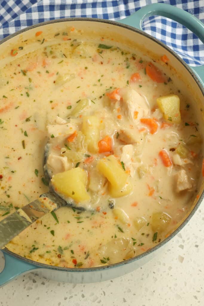 This Chicken Potato Soup is made with onions, celery, carrots, potatoes, and rotisserie chicken in a creamy cheesy broth topped with an easy three-ingredient bacon crumble.