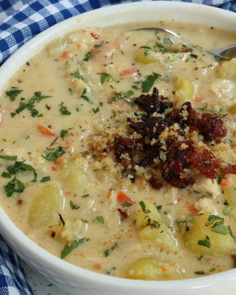 Close up of Chicken Potato Soup in a white bowl.