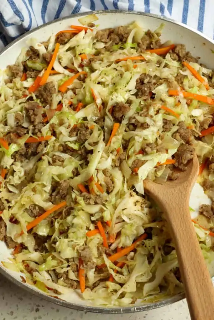 This low-carb pork egg roll bowl has all the best parts of an egg roll without the added guilt of deep frying! Tender veggies are tossed with seasoned pork sausage or ground pork.