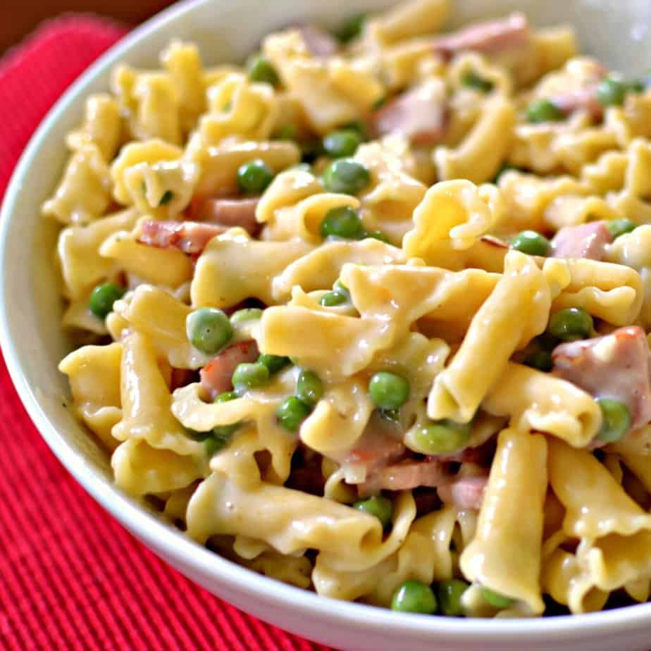 This Ham and Pea Campanelle combines smoky ham, sweet peas, and pasta in a lightly seasoned super creamy cheese sauce.