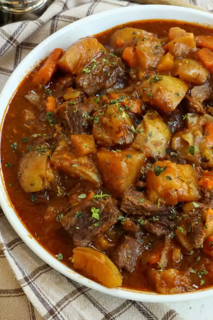 Quick and easy Instant Pot Beef Stew combines chuck roast, onions, potatoes, and carrots with paprika and thyme in a tasty beef sauce that is thickened right inside the instant pot.