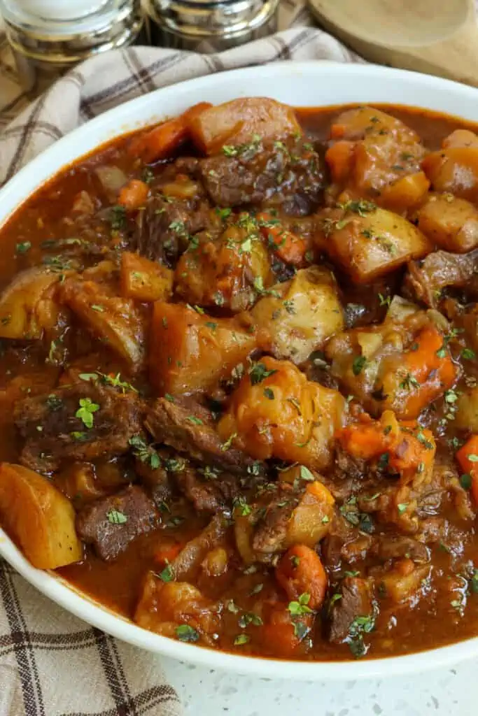 Delicious and easy Instant Pot Beef Stew is comfort food at its best with tender beef, onions, sweet carrots, and potatoes all in a tasty tomato beef sauce seasoned with paprika and thyme.