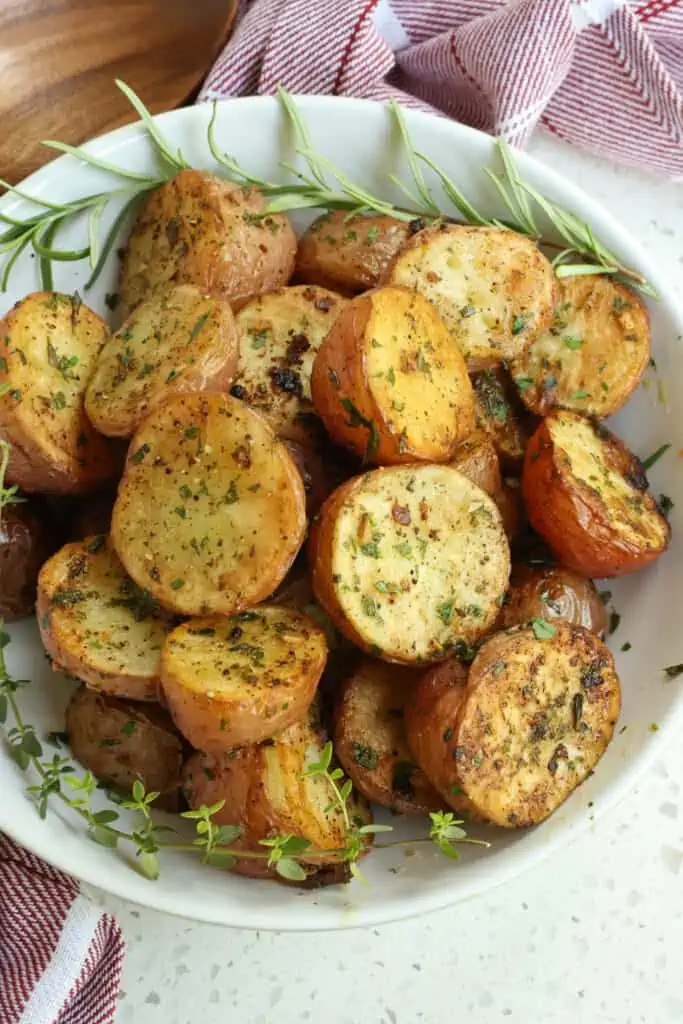 Classic roasted red potatoes with garlic, thyme, rosemary, and parsley. These potatoes are loaded with flavor from fresh herbs, kosher salt, and fresh ground black pepper. 