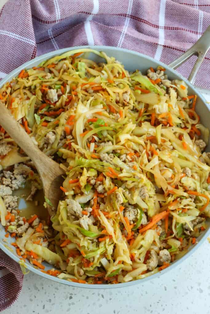 A quick and healthy Cabbage Stir Fry Recipe made with ground turkey or ground chicken, onions, cabbage, carrots, ginger, and garlic all in a sweet and savory sauce.
