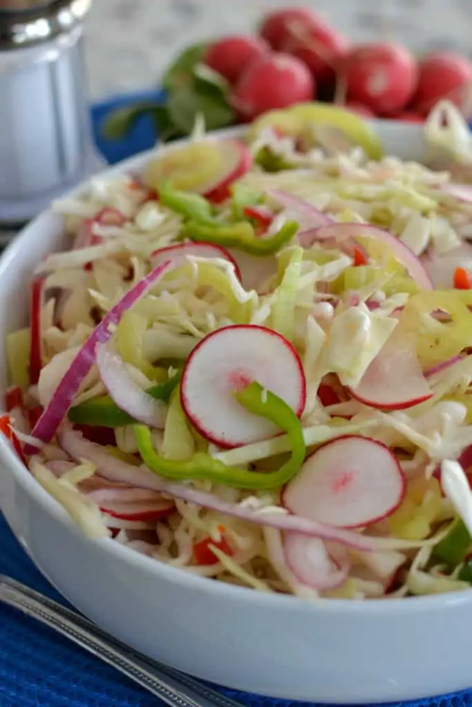 This Vinegar Coleslaw goes great with ribs, burgers, hot dogs, brats, chicken and pork.