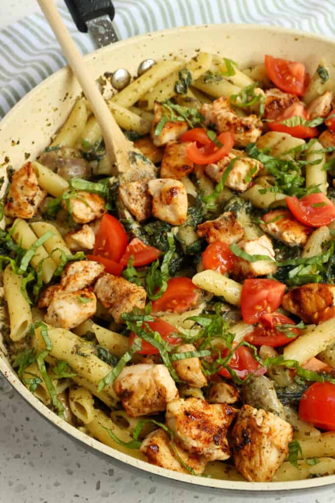 A deliciously easy and flavor-packed Chicken Pesto Pasta made with chicken breasts, mushrooms, spinach, and penne pasta all drenched in creamy pesto sauce.