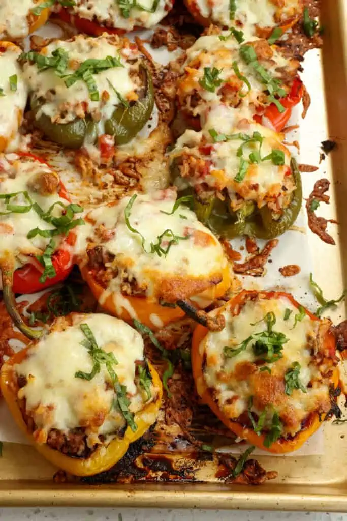 Easy Stuffed Bell Peppers with ground beef, garlic, and rice in a beefy tomato base with Italian seasoning all topped with mozzarella and baked to perfection. 