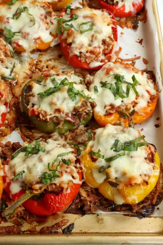 Delicious and easy Stuffed Bell Peppers with ground beef, onions, garlic, rice, and Italian seasoning all topped with a generous helping of melty Mozzarella Cheese.