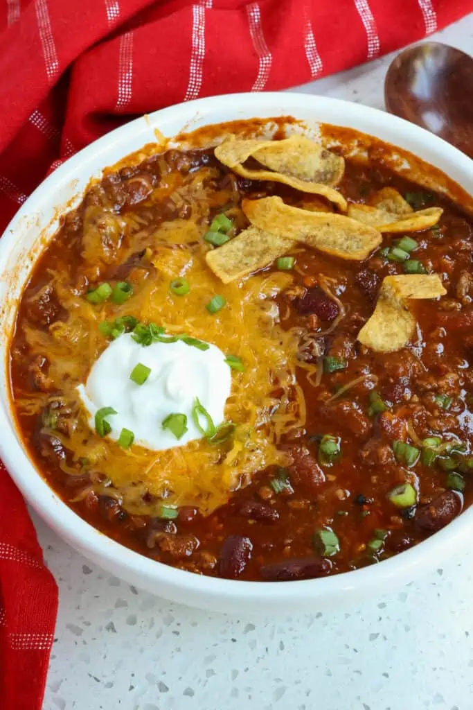 This Instant Pot Chili recipe is so full of flavor from crsip bacon, cocoa powder, fire roasted tomatoes, smoked paprika, brown sugar, and garlic. 