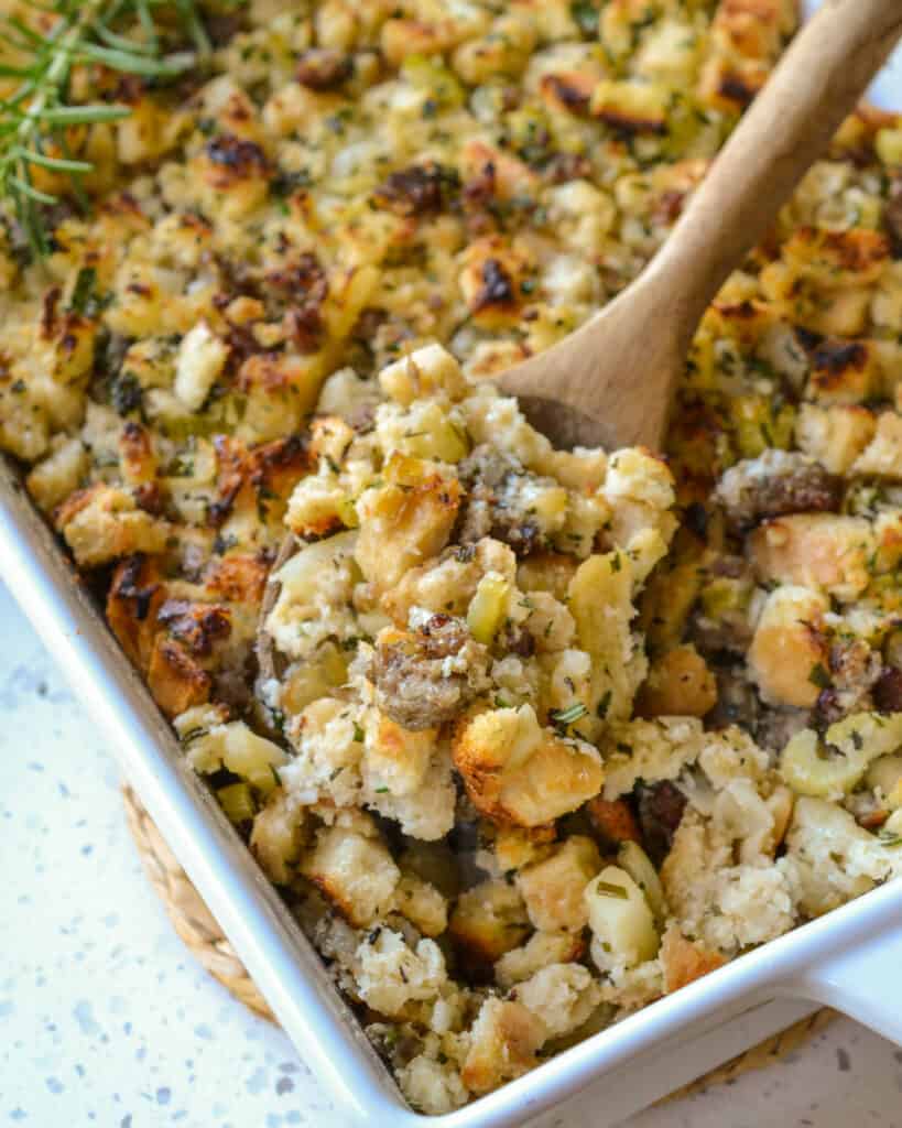 A delicious classic Thanksgiving Sausage Stuffing with onions, celery, garlic, pork sausage, and apples all seasoned with rosemary, thyme, and sage.