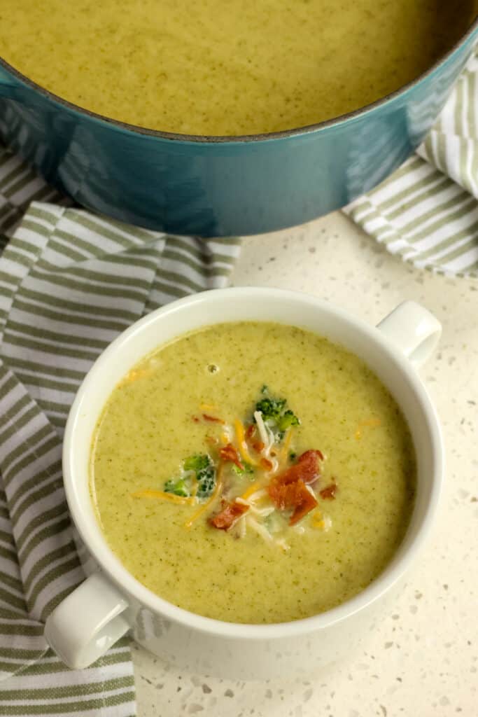 This Cream of Broccoli Soup combines onions, potatoes, garlic, and broccoli into an ultra-creamy soup with a splash of heavy cream all garnished with finely chopped broccoli, crisp bacon, and a sprinkle of cheese. 