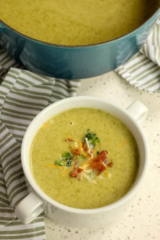 This Cream of Broccoli Soup combines onions, potatoes, garlic, and broccoli into an ultra-creamy soup with a splash of heavy cream all garnished with finely chopped broccoli, crisp bacon, and a sprinkle of cheese. 