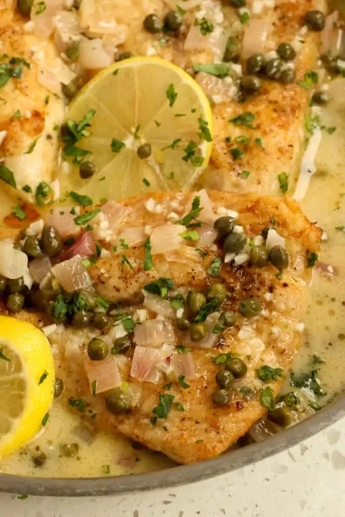 Easy Chicken Piccata is lightly breaded golden brown chicken breasts in a light lemon sauce with shallots, garlic, capers, and parsley.