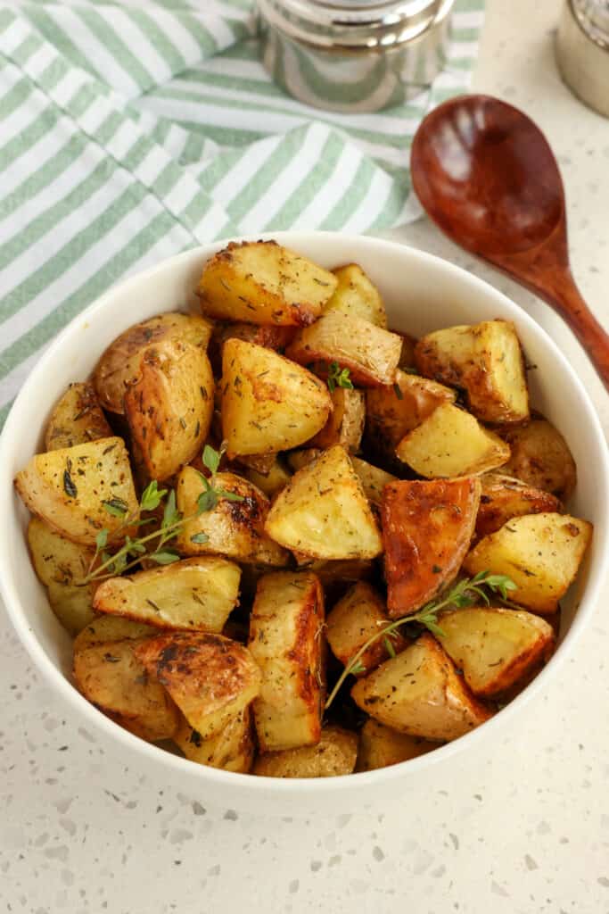 I prefer to leave the skins on for roasted potatoes, but you can certainly peel them if you like. 