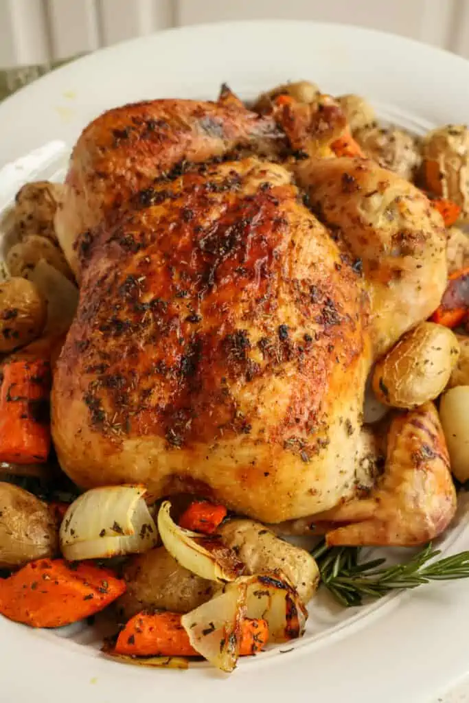 This Roasted Chicken is basted in butter seasoned with garlic, fresh rosemary, fresh thyme, kosher salt, and freshly ground black pepper for the ultimate comfort meal.  
