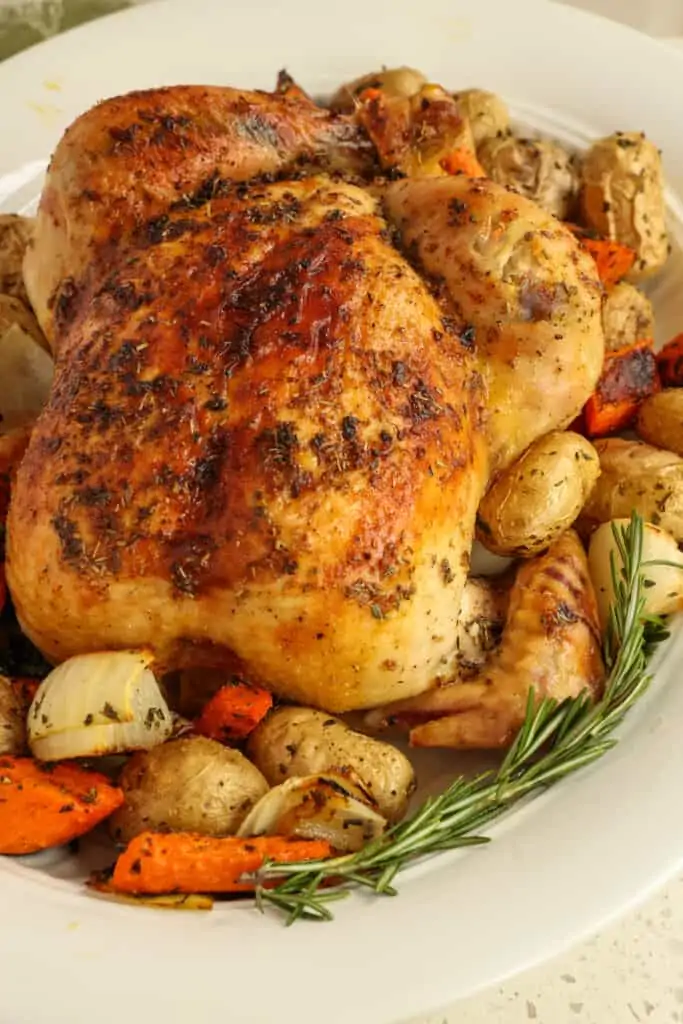 Classic slow Roasted Chicken basted with butter, garlic, thyme, and rosemary for tender flavorful chicken that melts in your mouth.