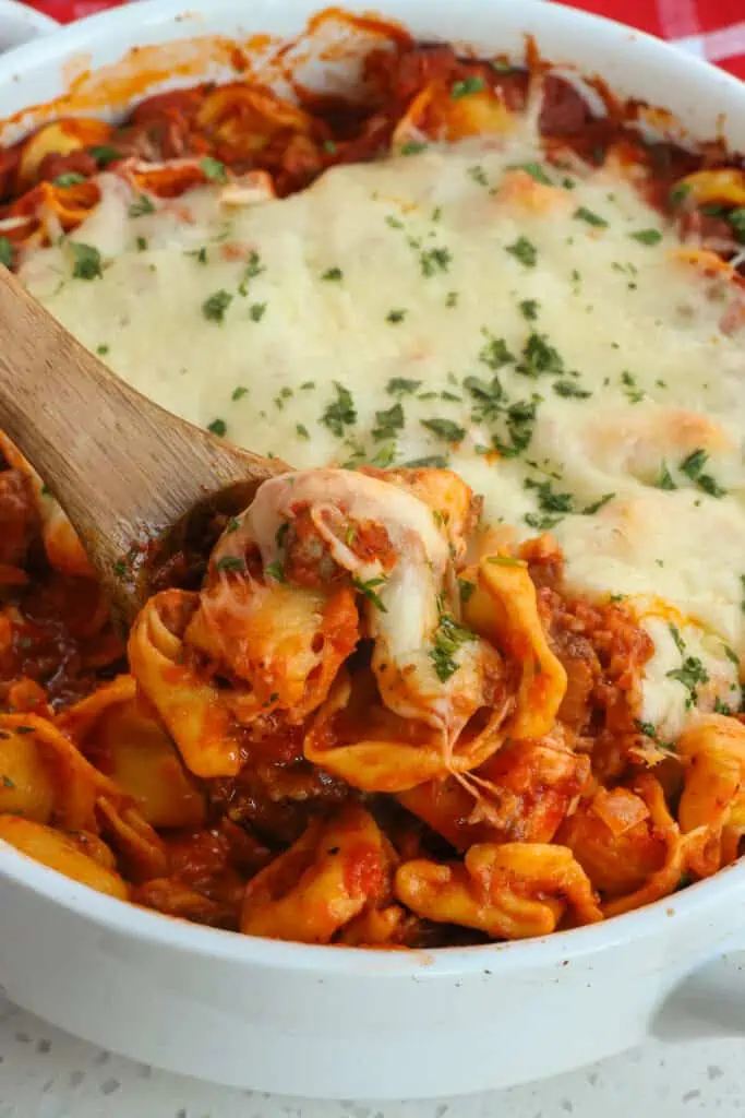 Easy Baked Tortellini with Italian Sausage, onions, garlic, and cheese tortellini in marinara sauce, all smothered with Parmesan cheese and mozzarella cheese.