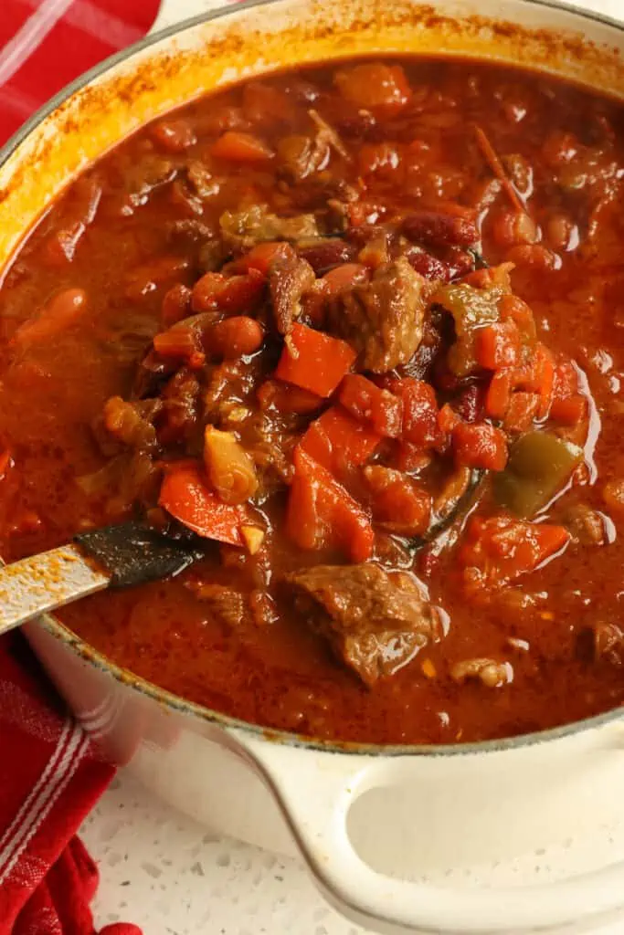 Hearty Chili con Carne combines slow-cooked melt-in-your-mouth tender chunks of chuck roast with kidney beans, onions, bell pepper, and garlic into a perfectly seasoned tomato-based chili. 