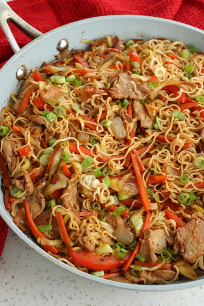 A delicious and flavorful Pork Loin Recipe with succulent pork tenderloin, onions, carrots, red bell pepper, shredded cabbage, and ramen noodles in a savory sauce with just a touch of sweetness and ginger.