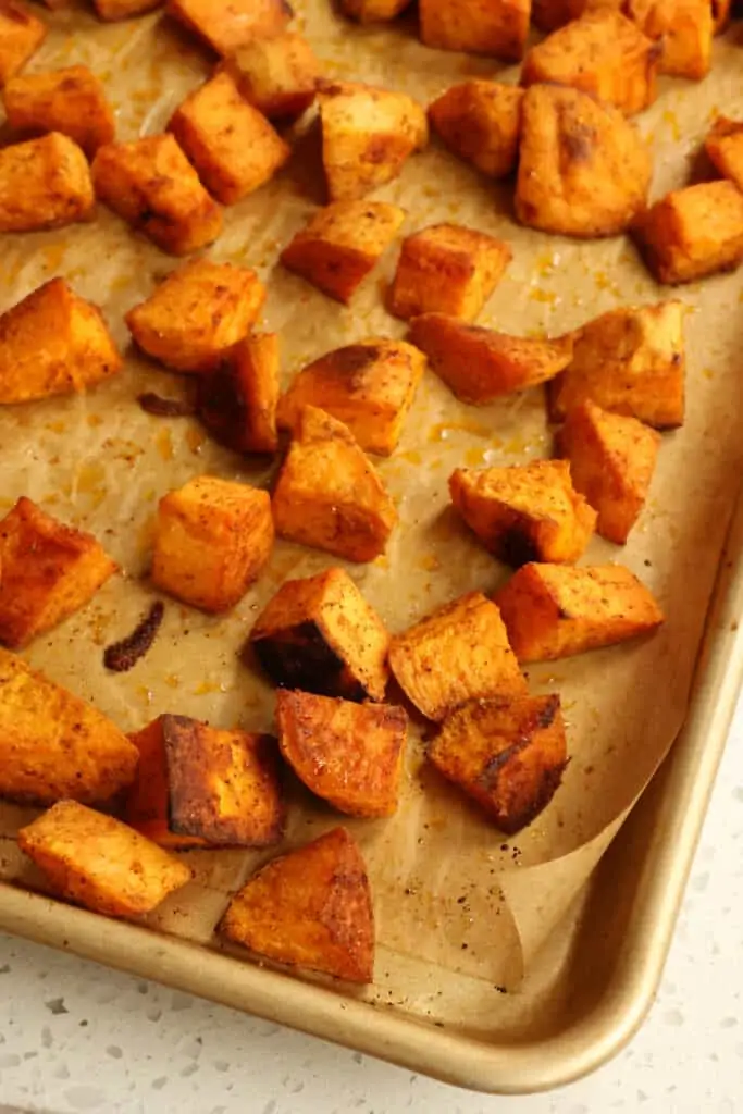 Perfectly seasoned Roasted Sweet Potatoes with ground cumin, paprika, and just a touch of ground cayenne pepper to make them sweet and sassy.