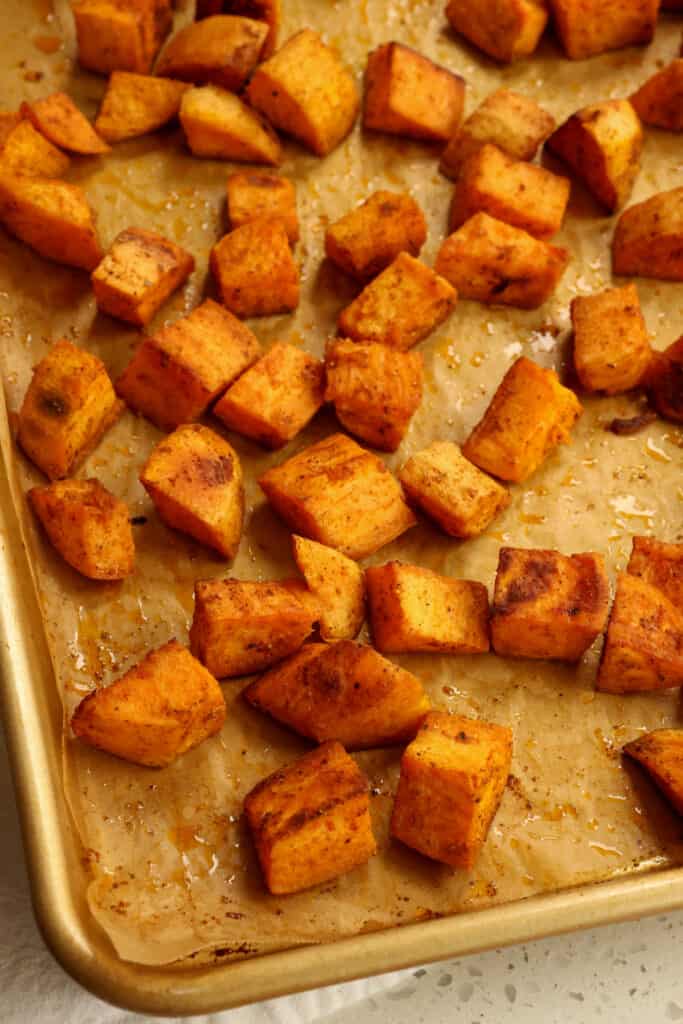 These Roasted Sweet Potatoes are so tasty and easy. They are made with common pantry ingredients and spices like cumin, paprika, and just a touch of cayenne pepper. 