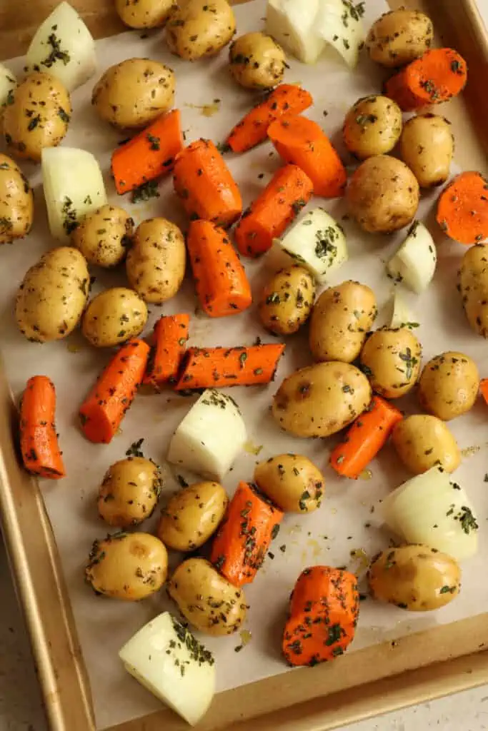 Cover a large baking sheet with parchment paper. Spread the vegetables over the parchment paper,