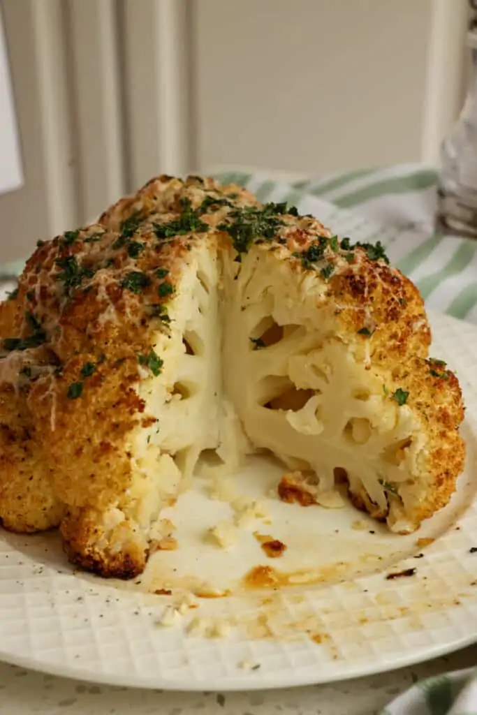 Tasty and healthy Whole Roasted Cauliflower is a cinch to make with common pantry spices and Parmesan cheese. 