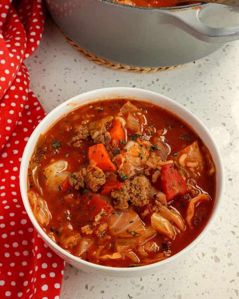 A white bowl with cabbage roll soup in it.