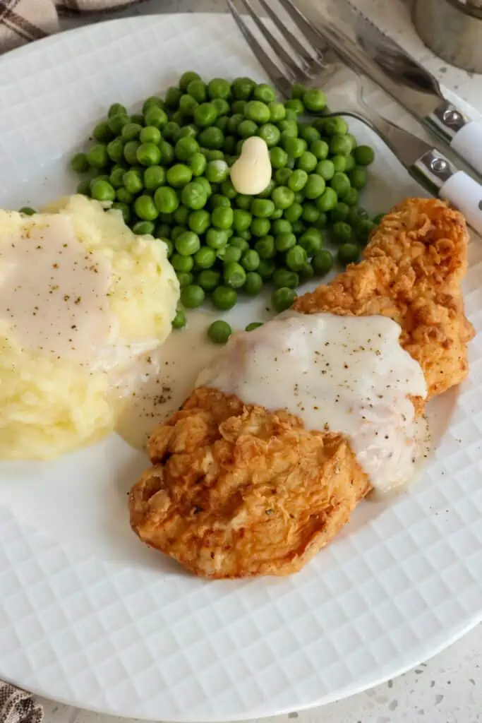 I love to serve Chicken Fried Chicken with creamy mashed potatoes and fresh green beans or baby peas.