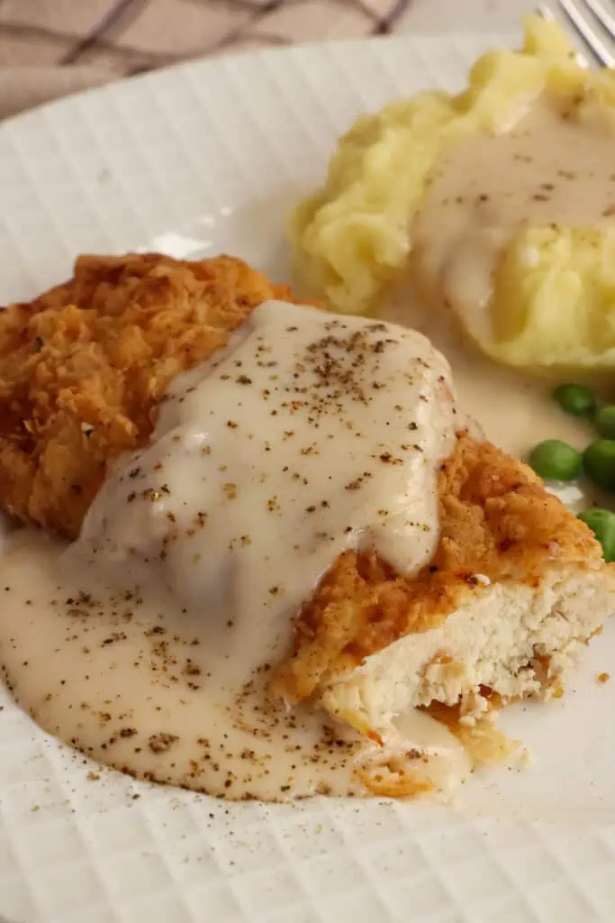 Chicken Fried Chicken is crispy breaded boneless skinless chicken breasts fried to golden perfection and served slathered with country white gravy seasoned with lots of fresh ground black pepper. 