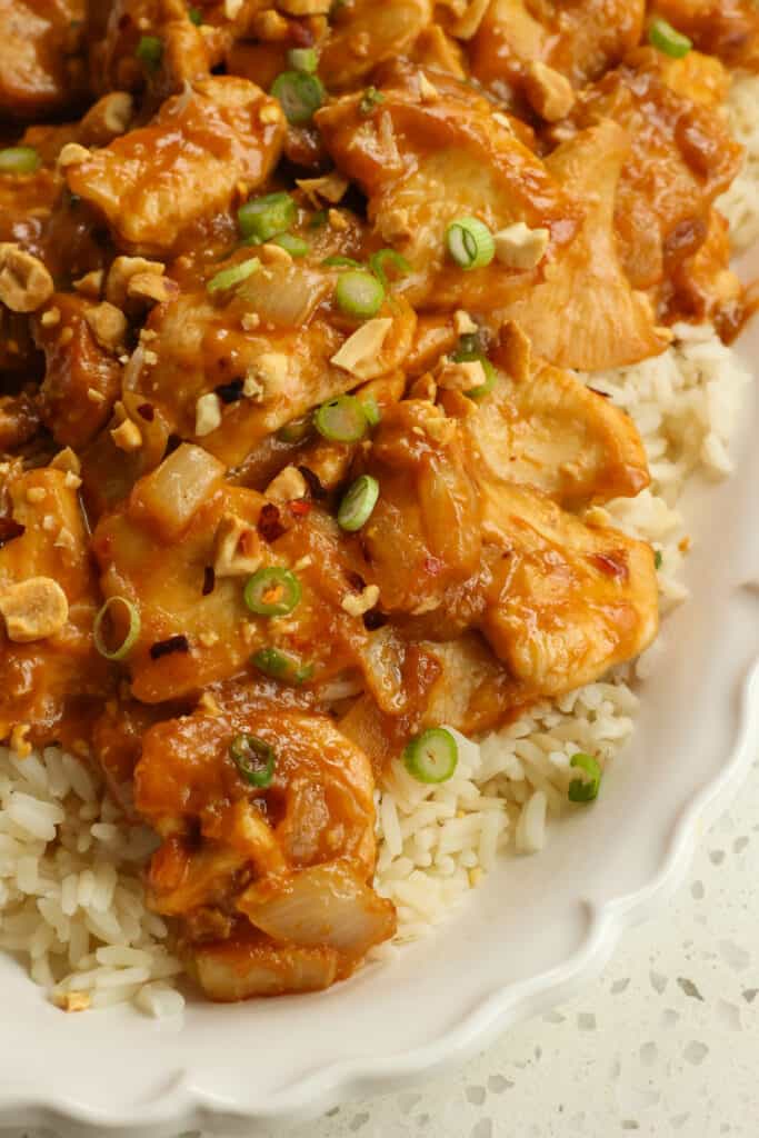 This easy Peanut Butter Chicken is tender browned chicken pieces tossed in a mouthwatering good ginger peanut sauce with thinly sliced green onions and chopped peanuts. 