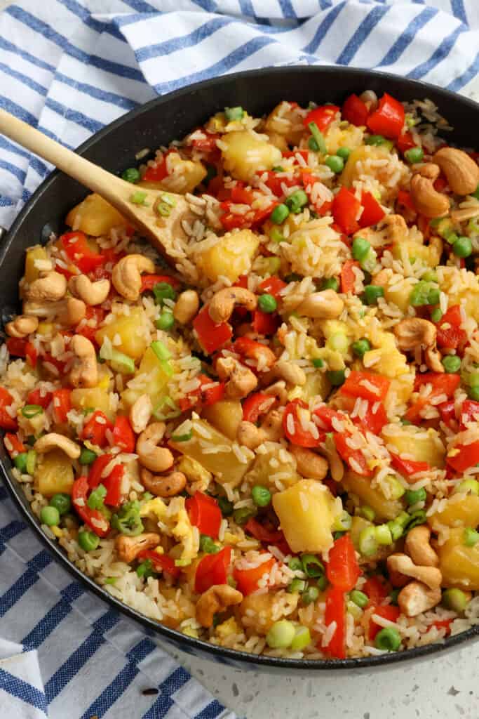 Thai Pineapple Fried Rice combines fresh pineapple, red bell pepper, peas, cashews, and fried rice into a taste-tantalizing experience with the flavors of ginger and sesame. 