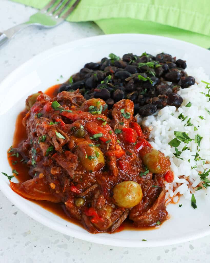 Ropa Vieja is a popular Cuban dish with tender slow cooked shredded beef, onions, bell pepper, olives, and capers in a rich tomato-based sauce that is loaded with flavor. 