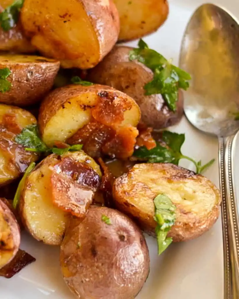 An easy roasted red potato salad sprinkled with crispy bacon and fresh Italian parsley, all drizzled with a tasty honey mustard dressing. 