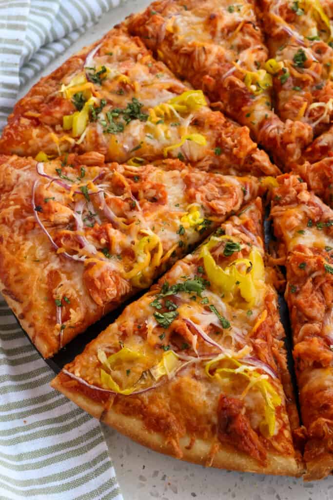 An easy Barbecue Chicken Pizza made with ready-made pizza dough, rotisserie chicken, and barbecue sauce.  