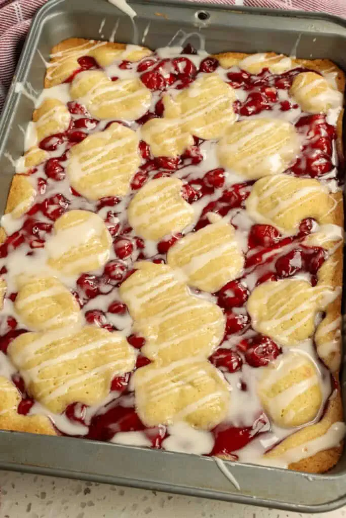 Easy to make Cherry Pies bars with a buttery base and topping and an easy glaze.