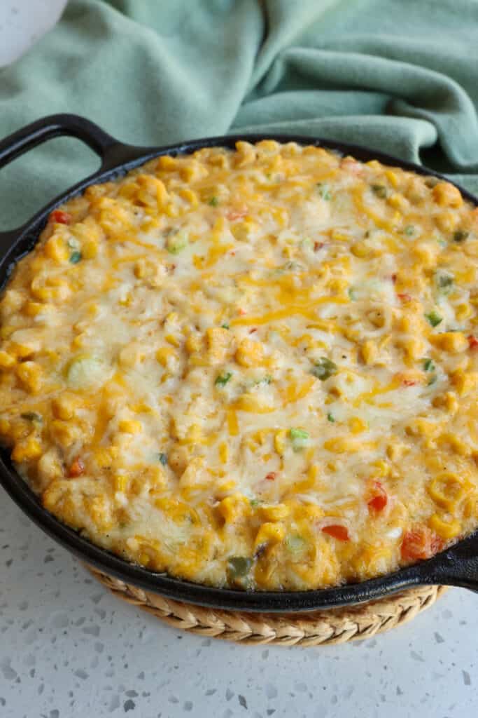 This creamy Corn Dip with corn, onions, peppers, garlic, green onions, jalapenos, Monterey Jack, and cheddar cheese is delicious, both hot and cold. 