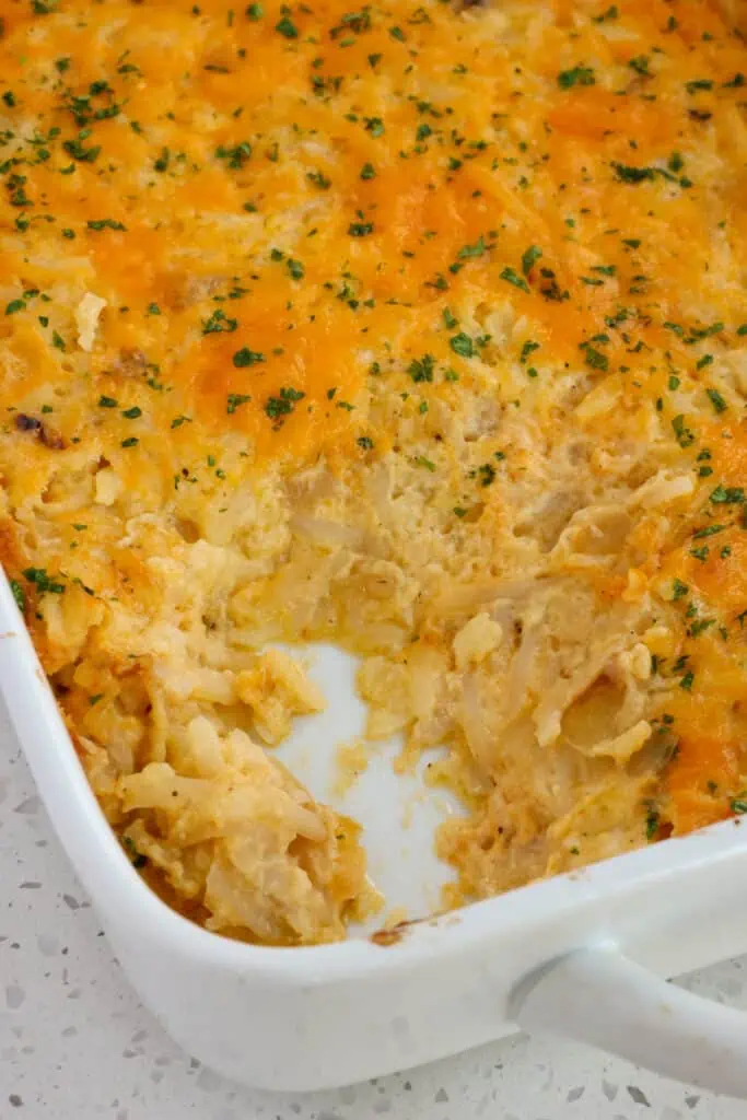 This amazing cheesy shredded Hashbrown Casserole is a cinch to make with shredded frozen hashbrowns, onions, garlic, canned cheddar soup, sour cream, and butter. 