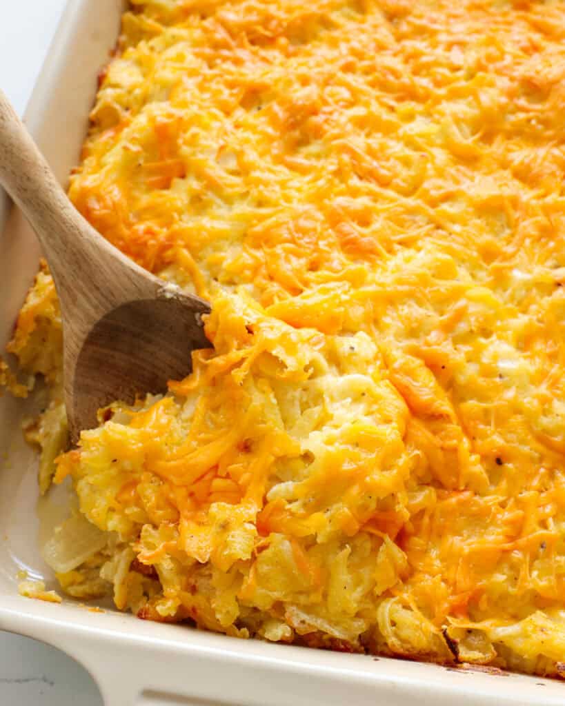 A close up view of cheesy hashbrown casserole. 