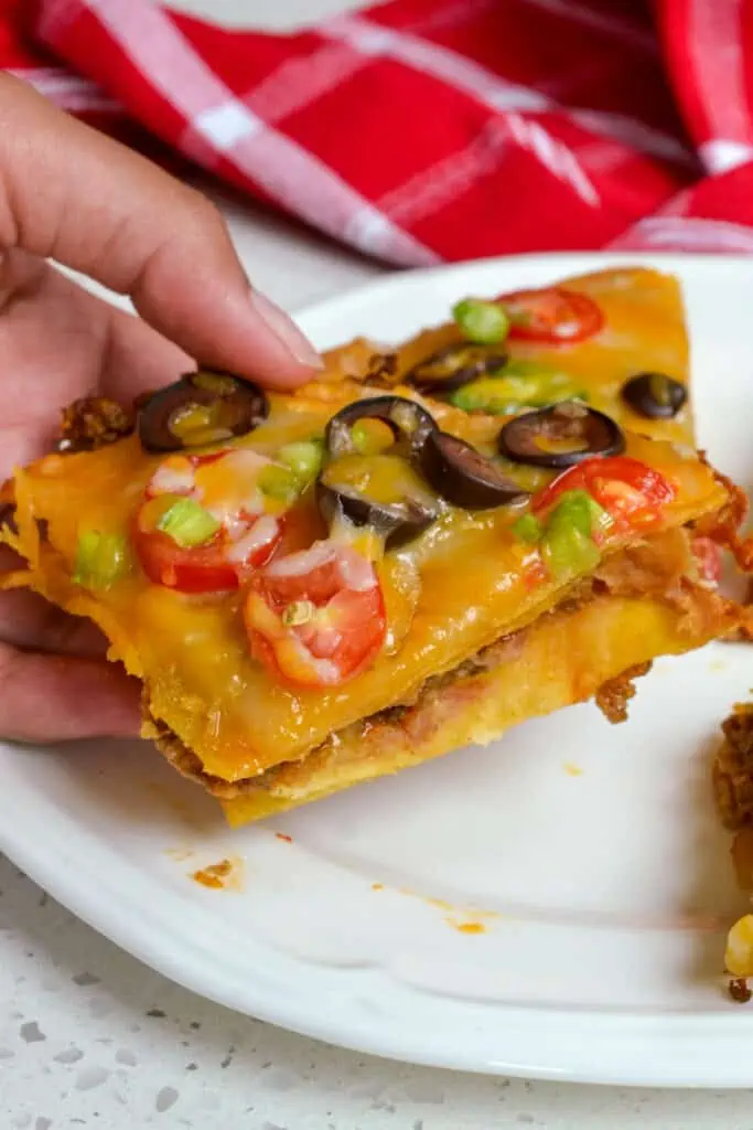 These delectable copycat Mexican pizzas are double-decker crispy fried corn tortilla pizzas stuffed with taco-seasoned beef, refried beans, cheddar, and Monterey Jack Cheese.  