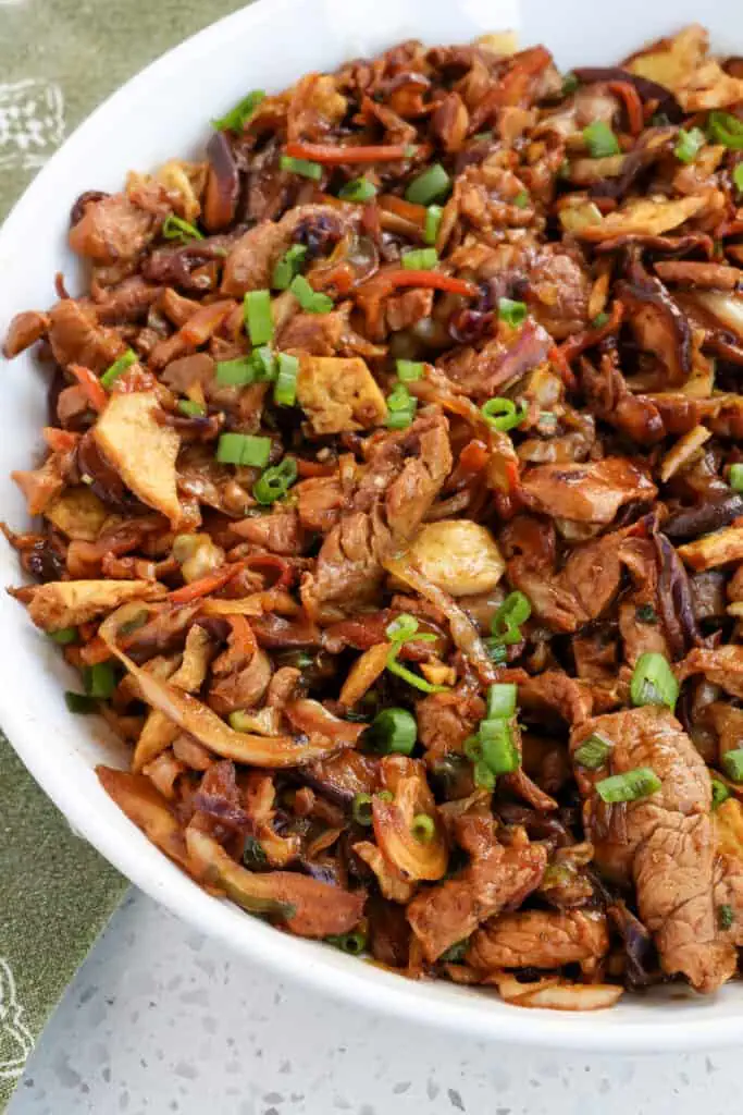 Moo Shu Pork combines marinated, thin, tender pieces of pork stir fried with cabbage, mushrooms, and eggs in a savory sauce with the flavors of garlic and ginger.